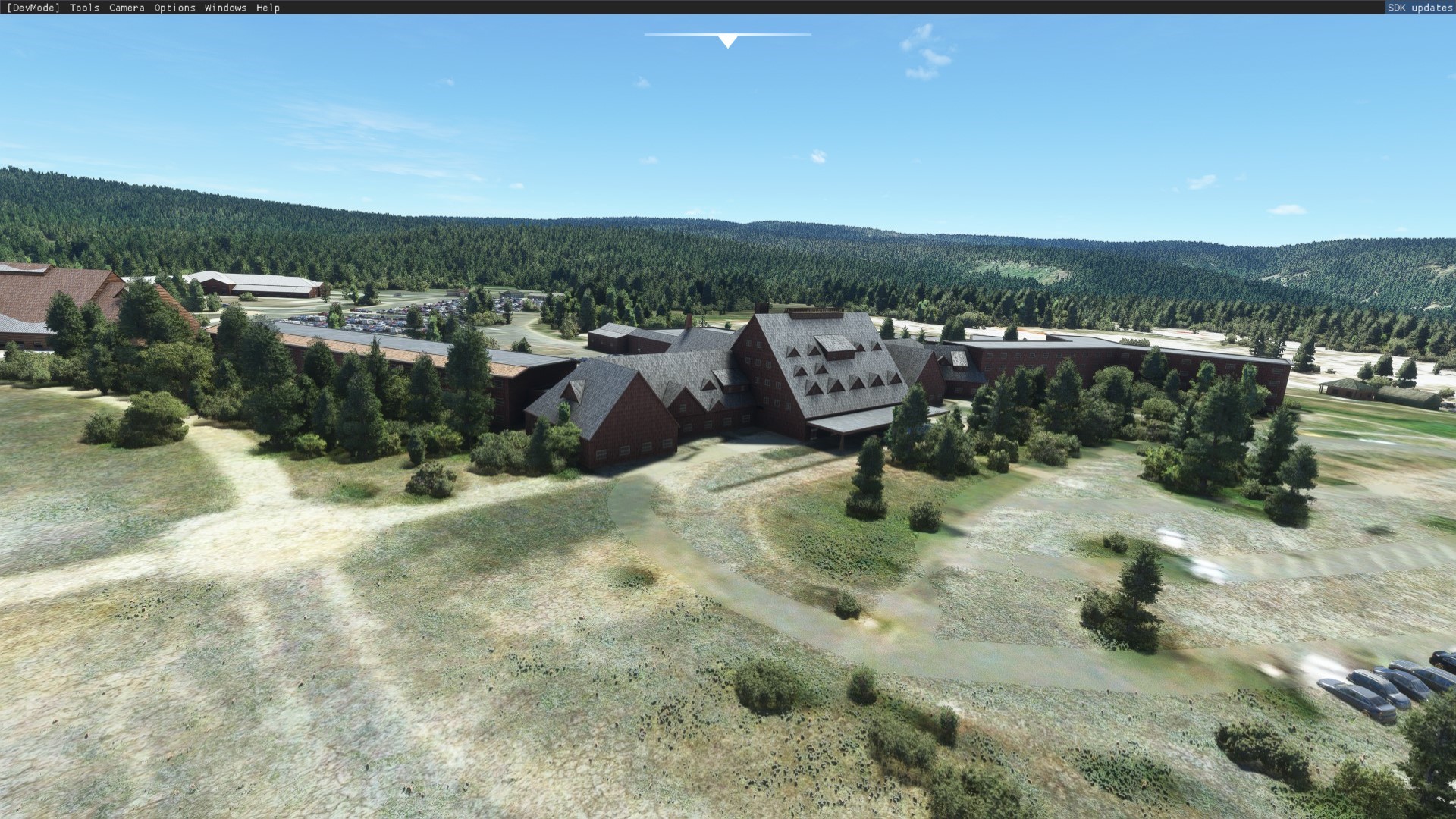 aerial view of a Yellowstone lodge and forest for West Yellowstone Airport (KWYS) by X-Codr Designs in MSFS